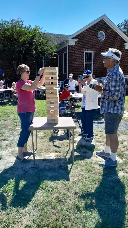 Sara Alvatar, left, and the Rev. Eddie Jusino play Giant Jenga.